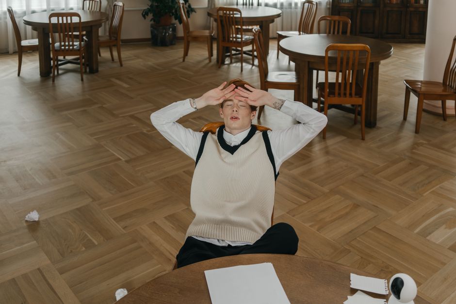 student stressed over books and phone with news notifications - young adult mental health student stressed over books and phone with news notifications - young adult mental health