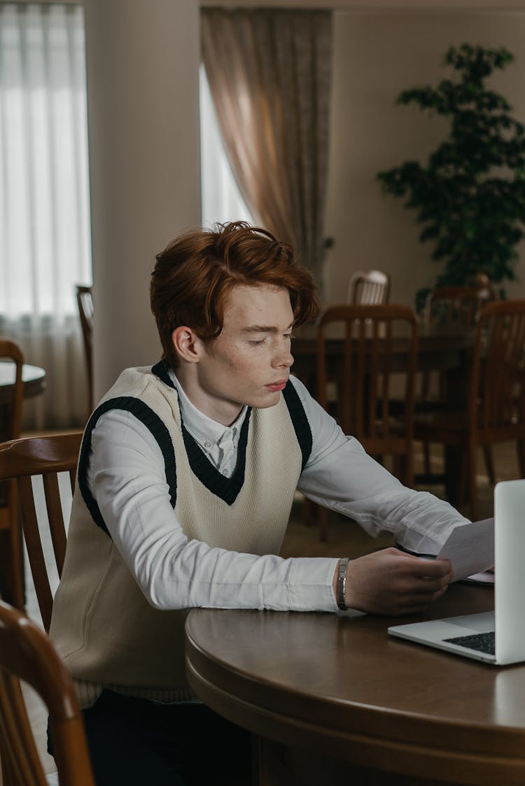 
A Man With Freckles Reading A Document