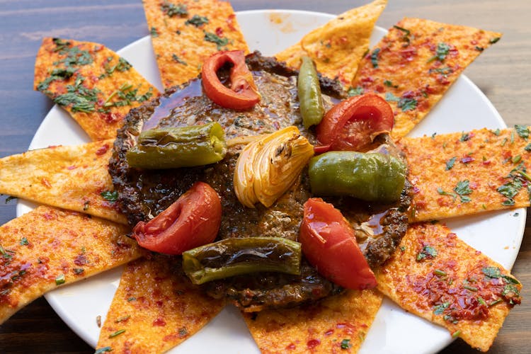 Slices Of Pizza With Patty And Tomatoes And Peppers On Plate