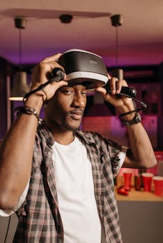 A man in a plaid shirt trying a VR headset in a cozy indoor setting.