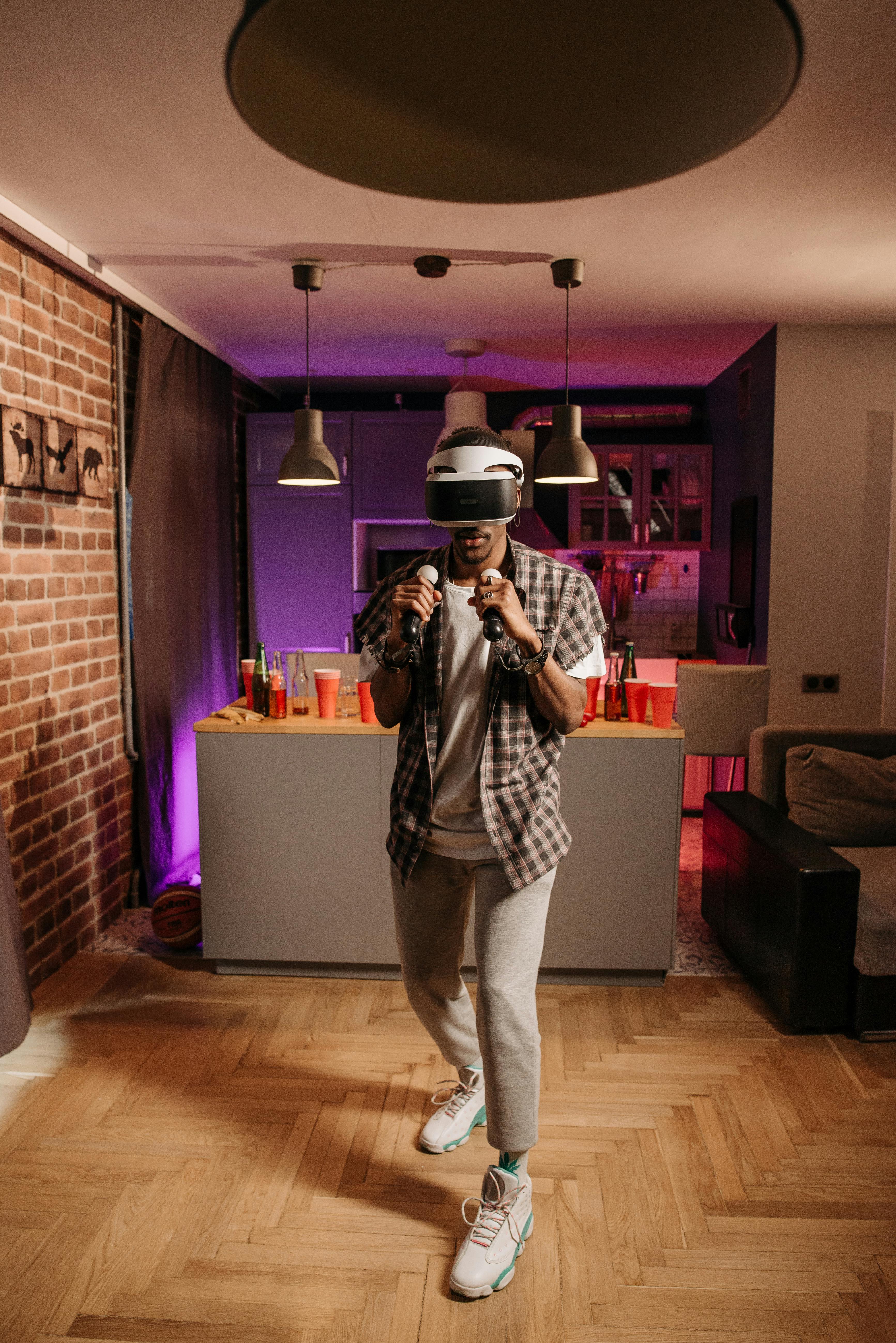 Man immersed in virtual reality gaming at home, showcasing modern leisure.