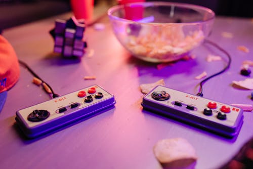 A Pair of Joysticks on Gray Table