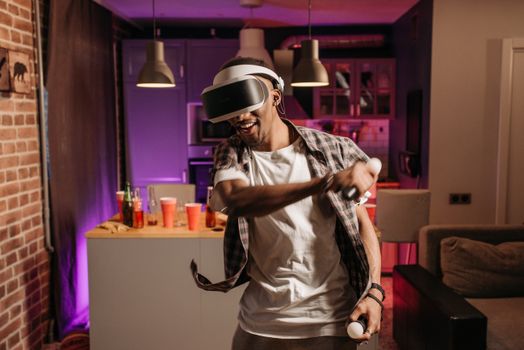 A man enjoying virtual reality gaming indoors with a VR headset.