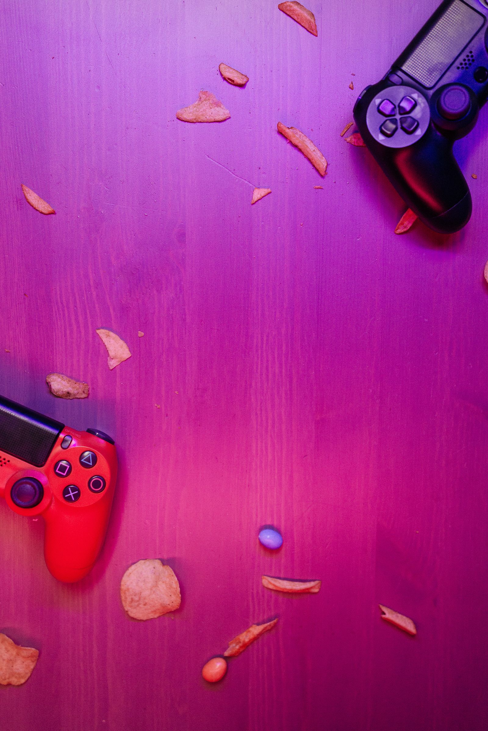 Close-up of hands holding a gaming controller with soft neon lighting