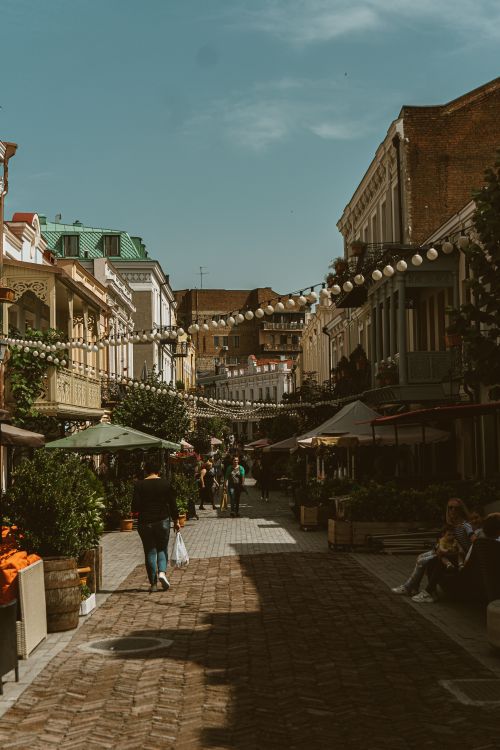 Street life in Tbilisi with pedestrians, cafés and Georgian architecture