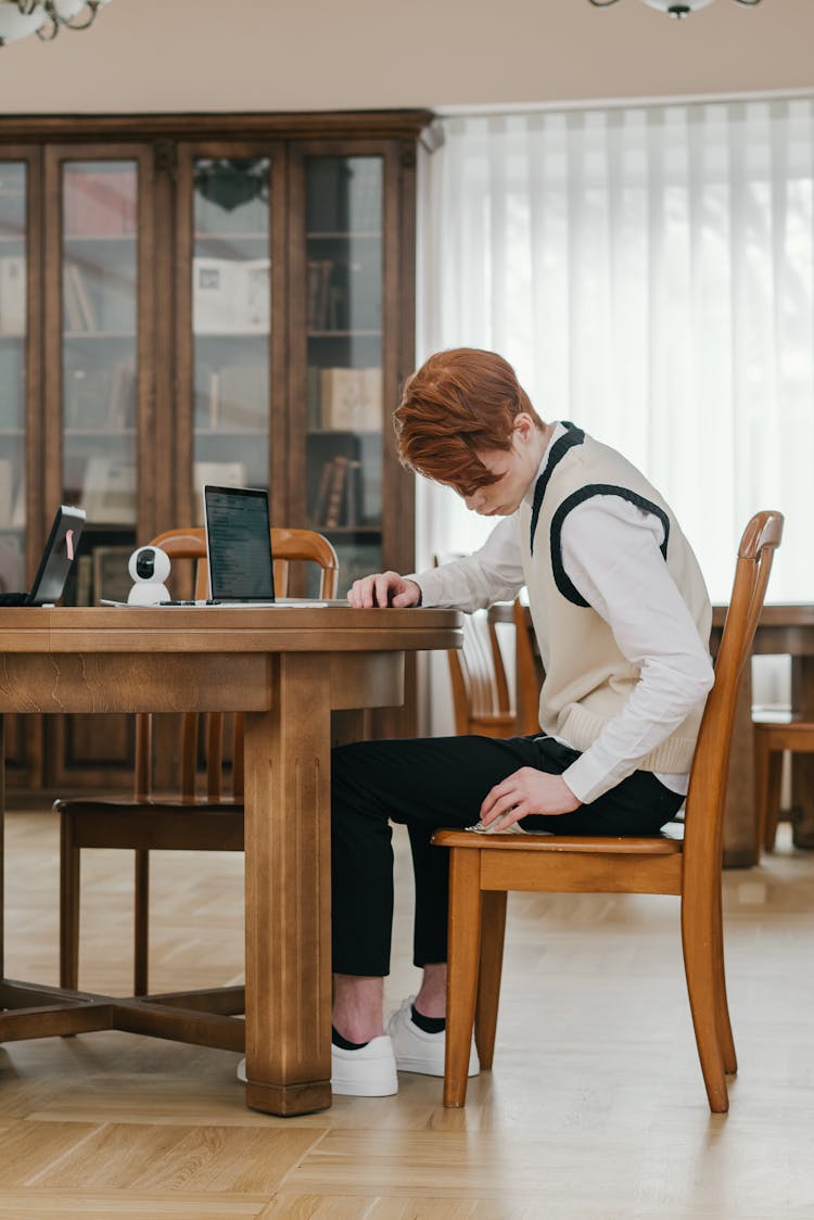 Student Sitting On A Wooden Chair