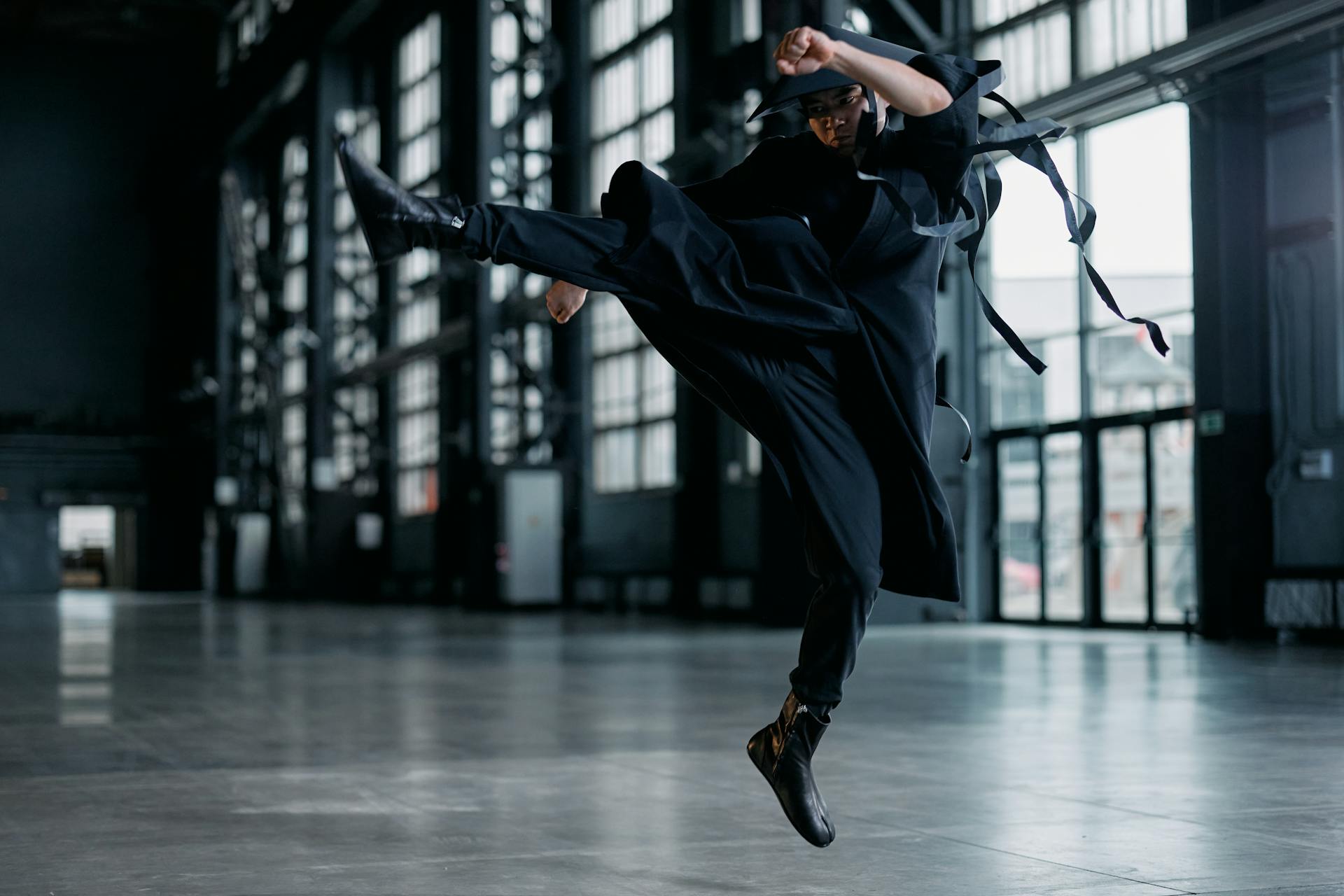 Cosplayer in a Game Character Costume Doing a Jump Kick