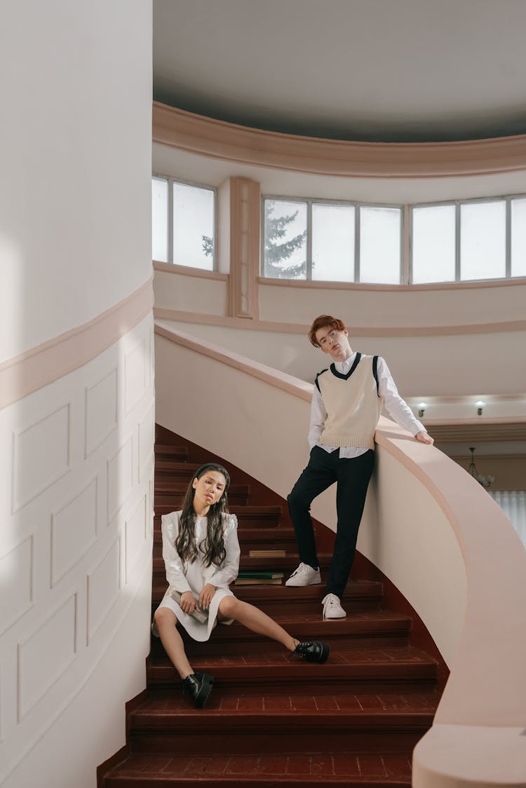 A Man And A Woman Posing On The Stairs