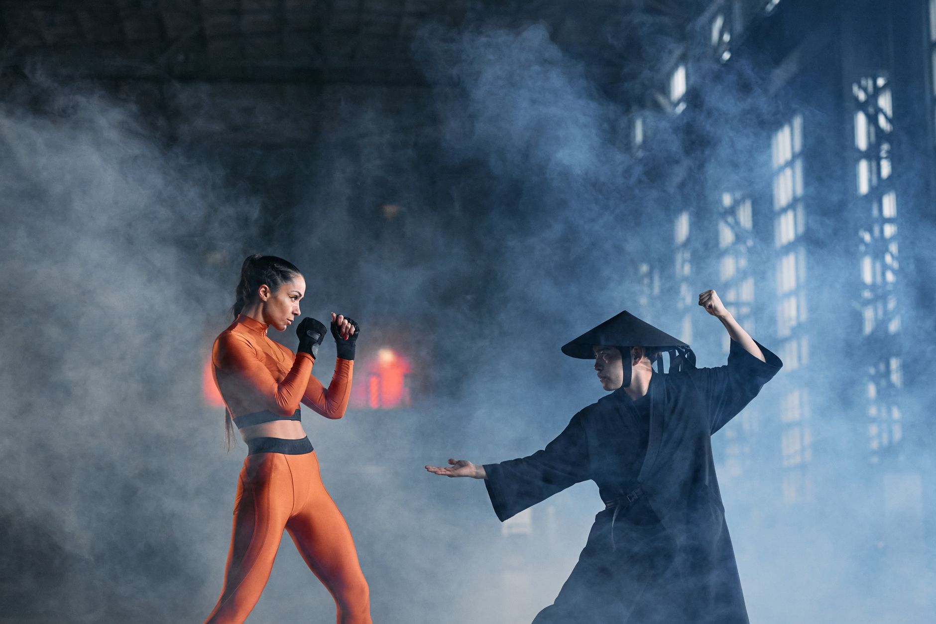 A captivating indoor scene of two cosplayers engaging in a dynamic martial arts duel.