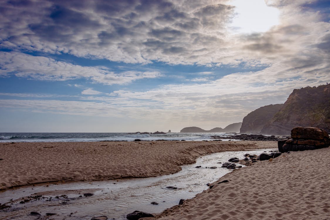 A Beach under a Cloudy Sky