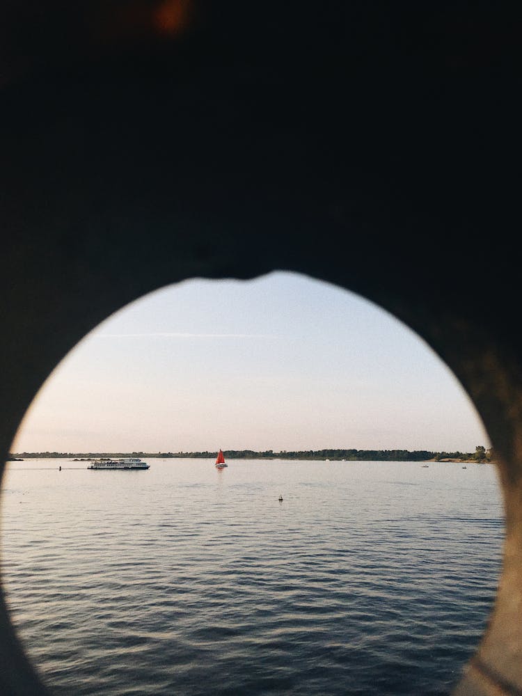 Vessels In Sea Water At Sunset