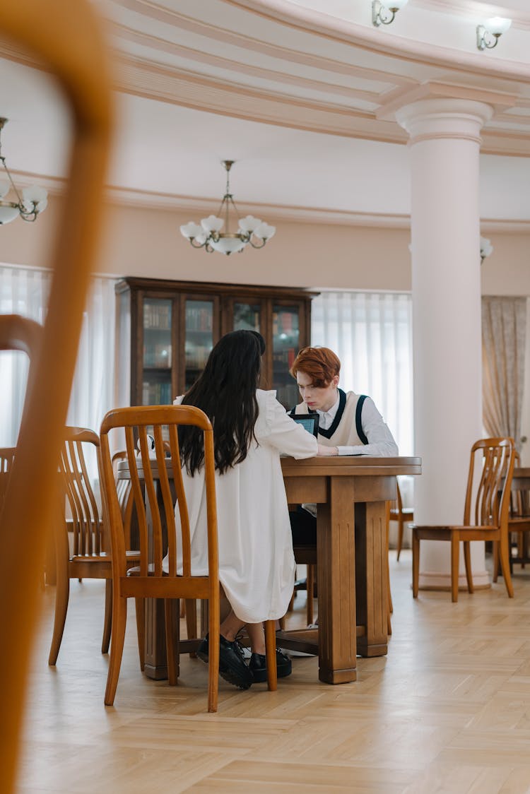 Photo Of A Girl And A Boy Studying In A Library