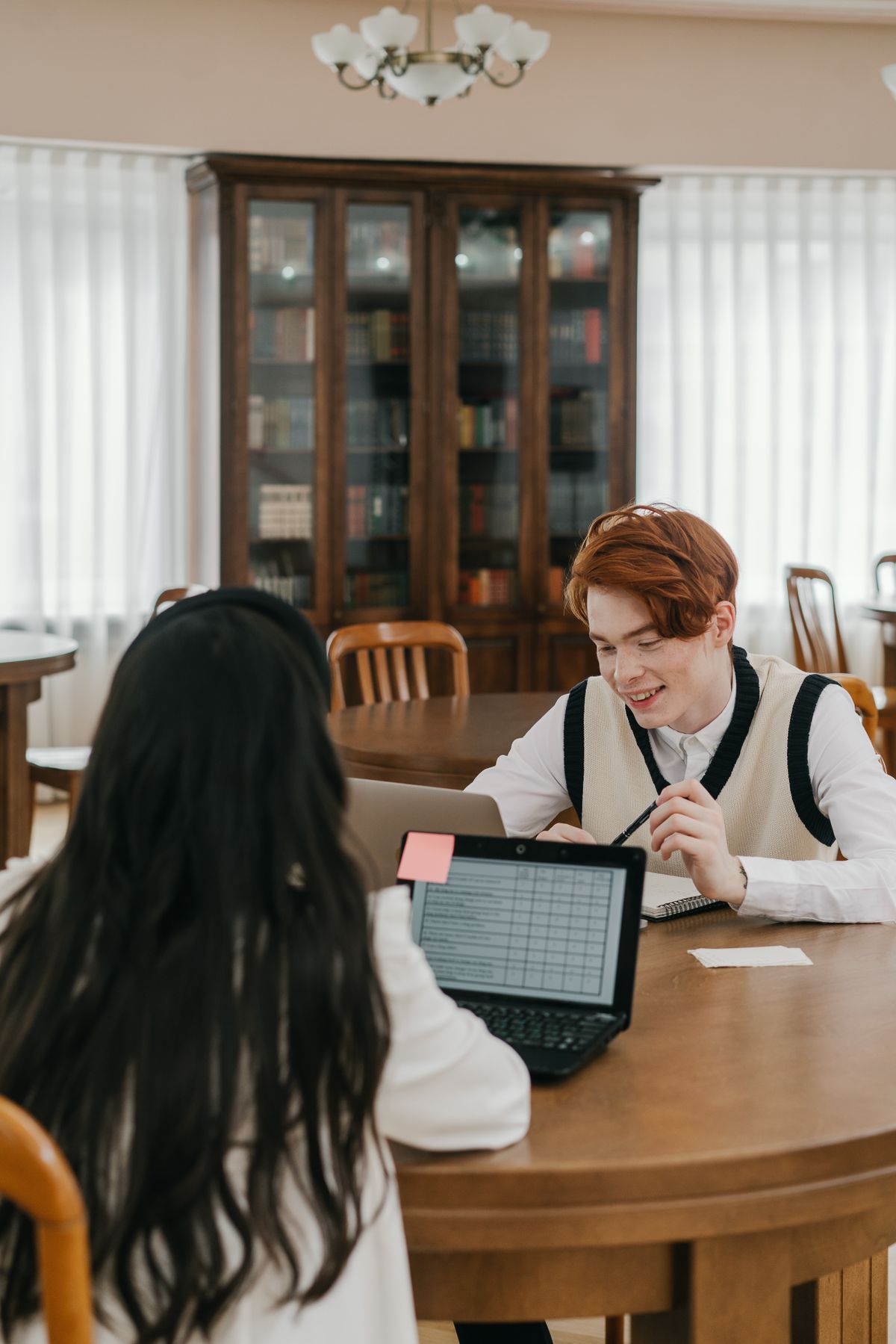 Students working together with a laptop while conducting academic research