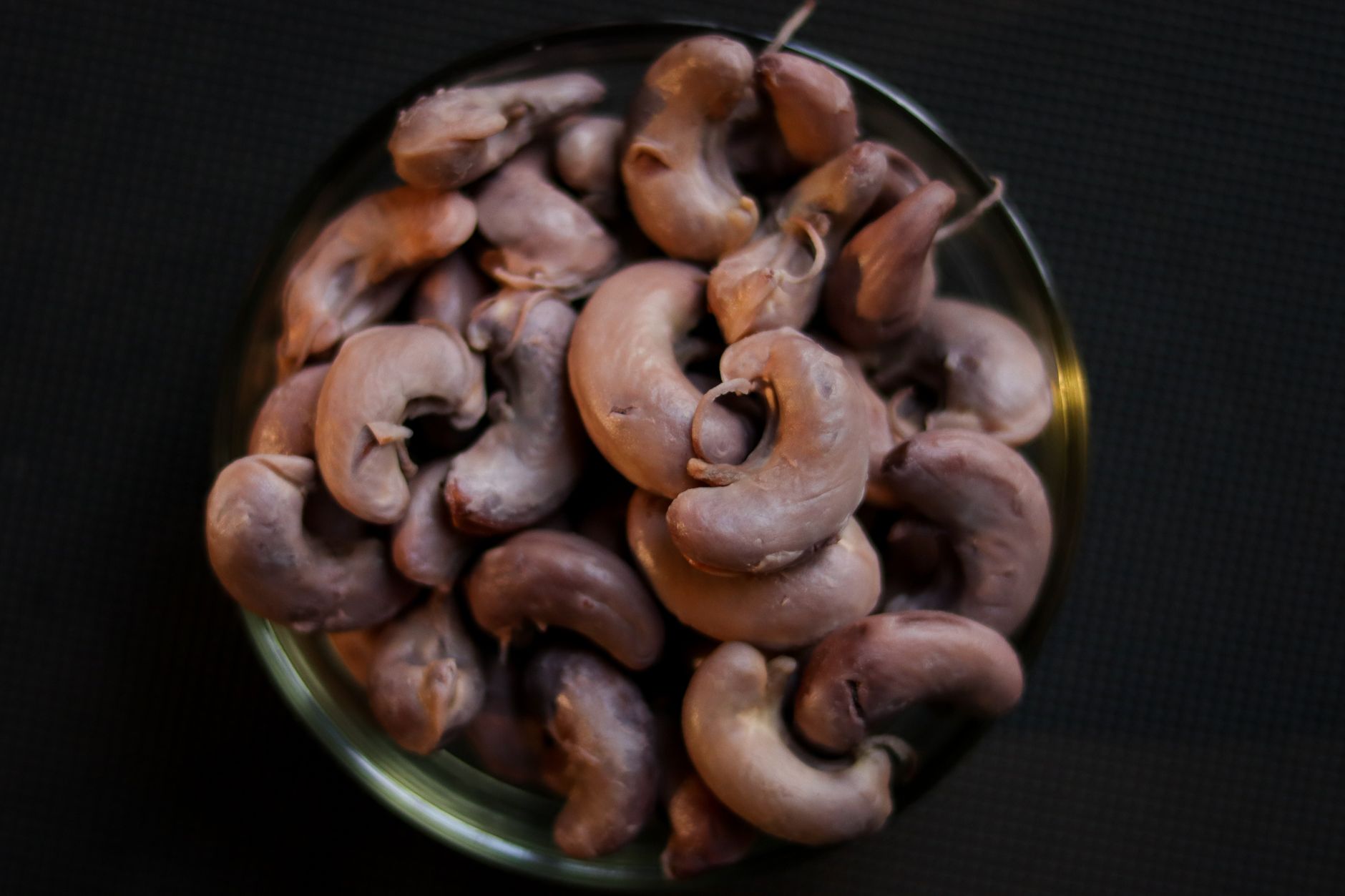 selenium for long covid recovery — Top view of raw cashew nuts piled in a bowl, perfect for food and ingredient themes.