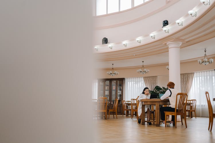 College Students Using Laptops In The Library