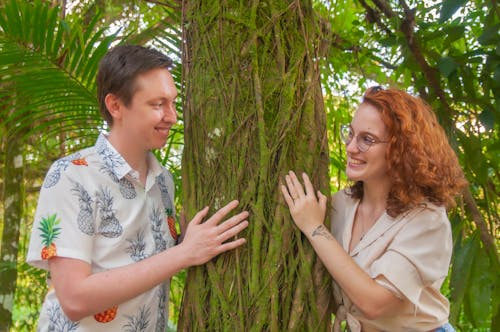 Man and Woman Standing Beside a Tree