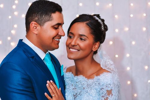 Free Joyful bride and groom smiling on their wedding day, elegantly dressed for the special occasion. Stock Photo