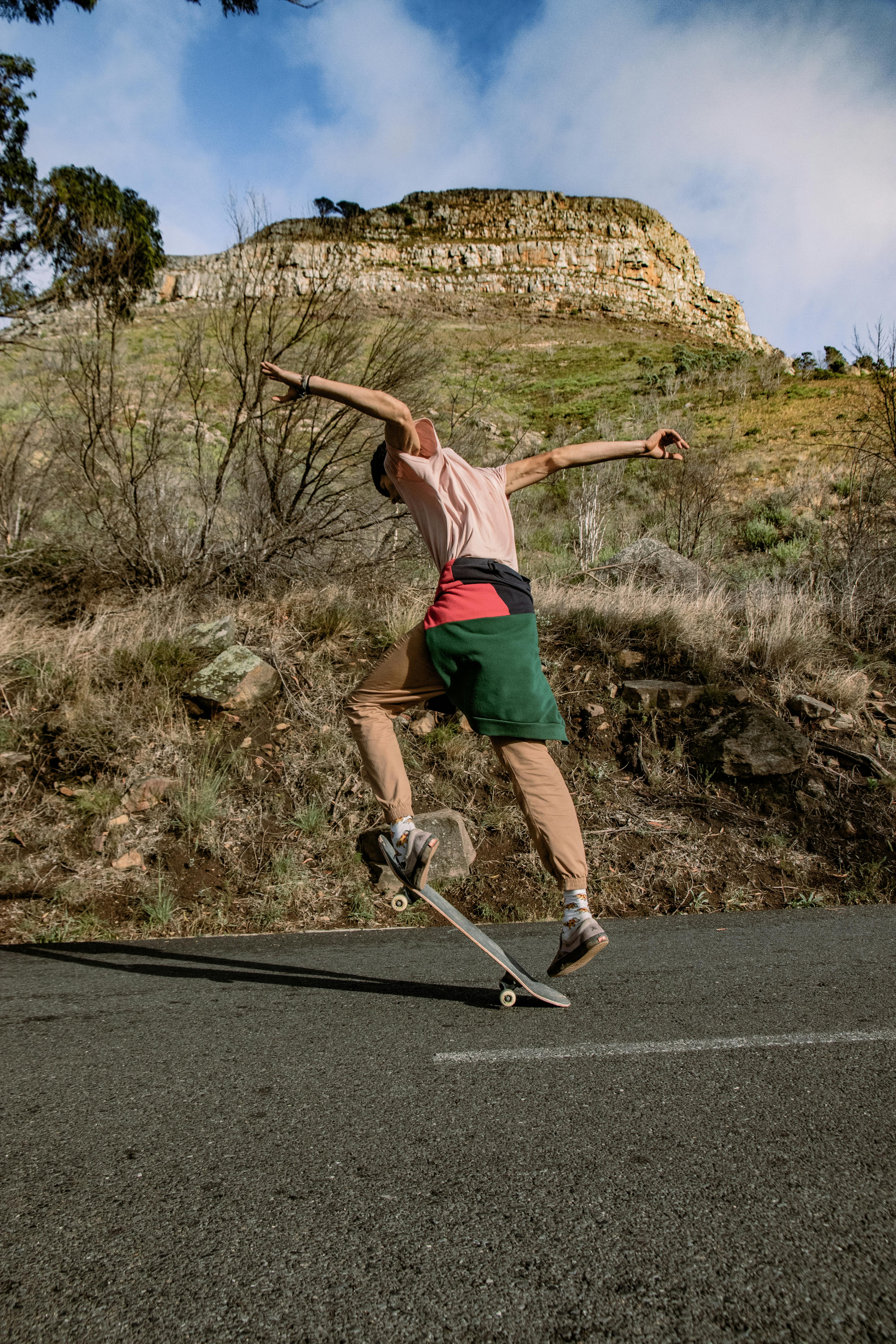 Man Riding a Skateboard on Asphalt Road · Free Stock Photo