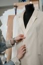 Person Holding a White Blazer