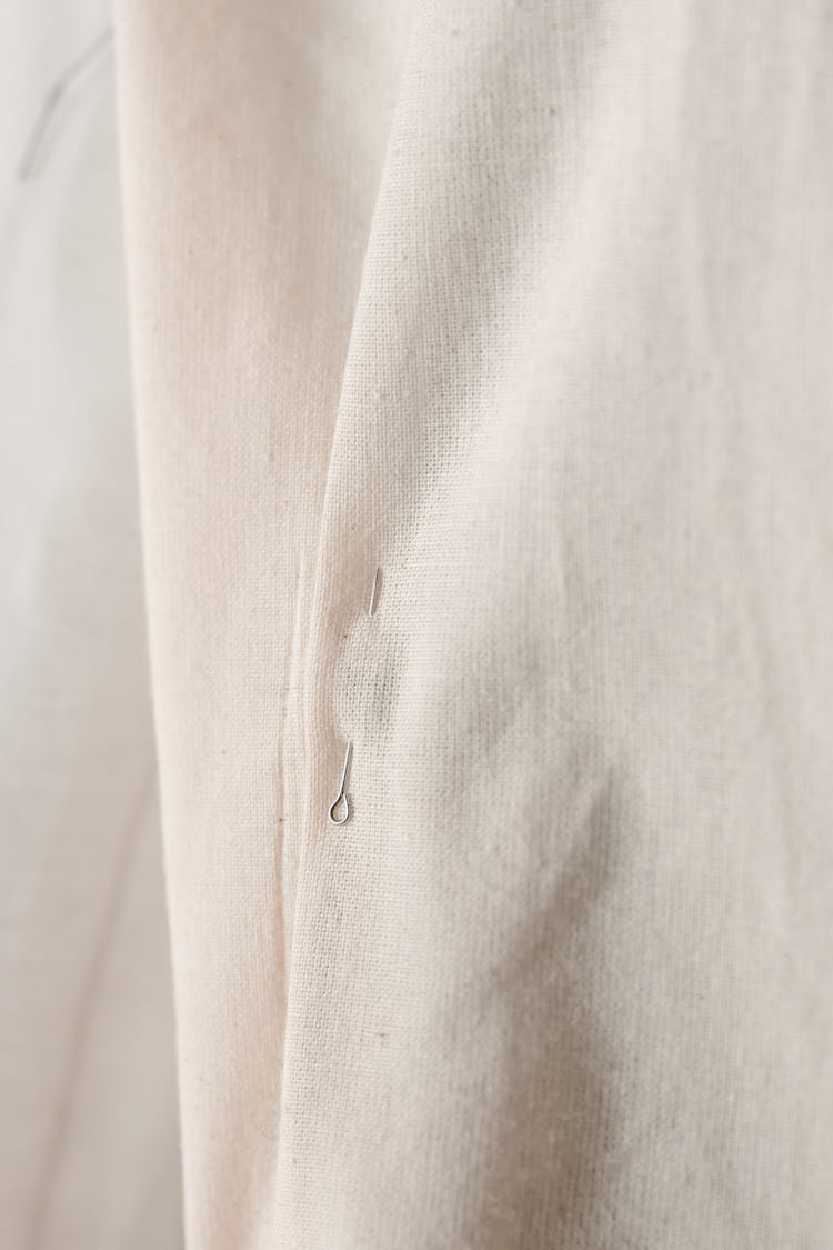 Close-Up Photo Of A Pin In A White Cloth