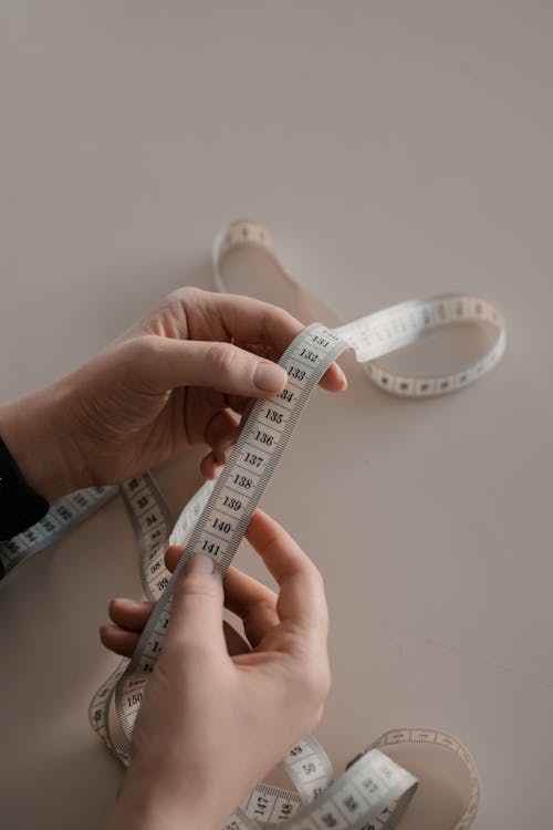 Free Hands Holding Tape Measure Stock Photo