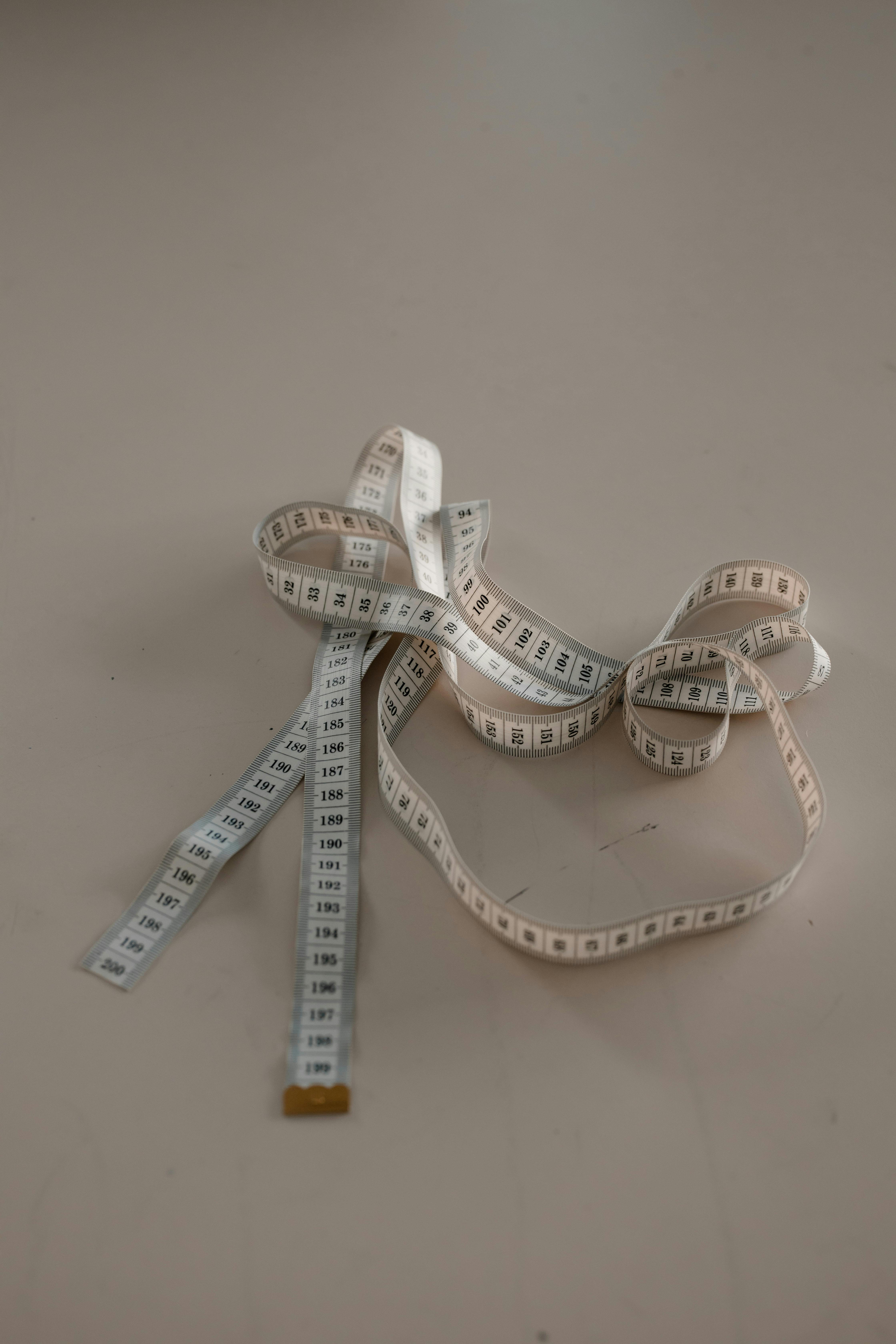 photo of tape measure on white surface