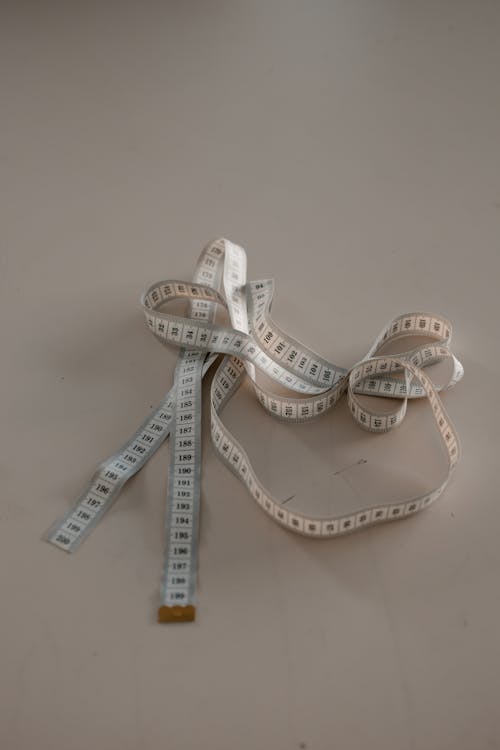 Free Photo of Tape Measure on White Surface Stock Photo