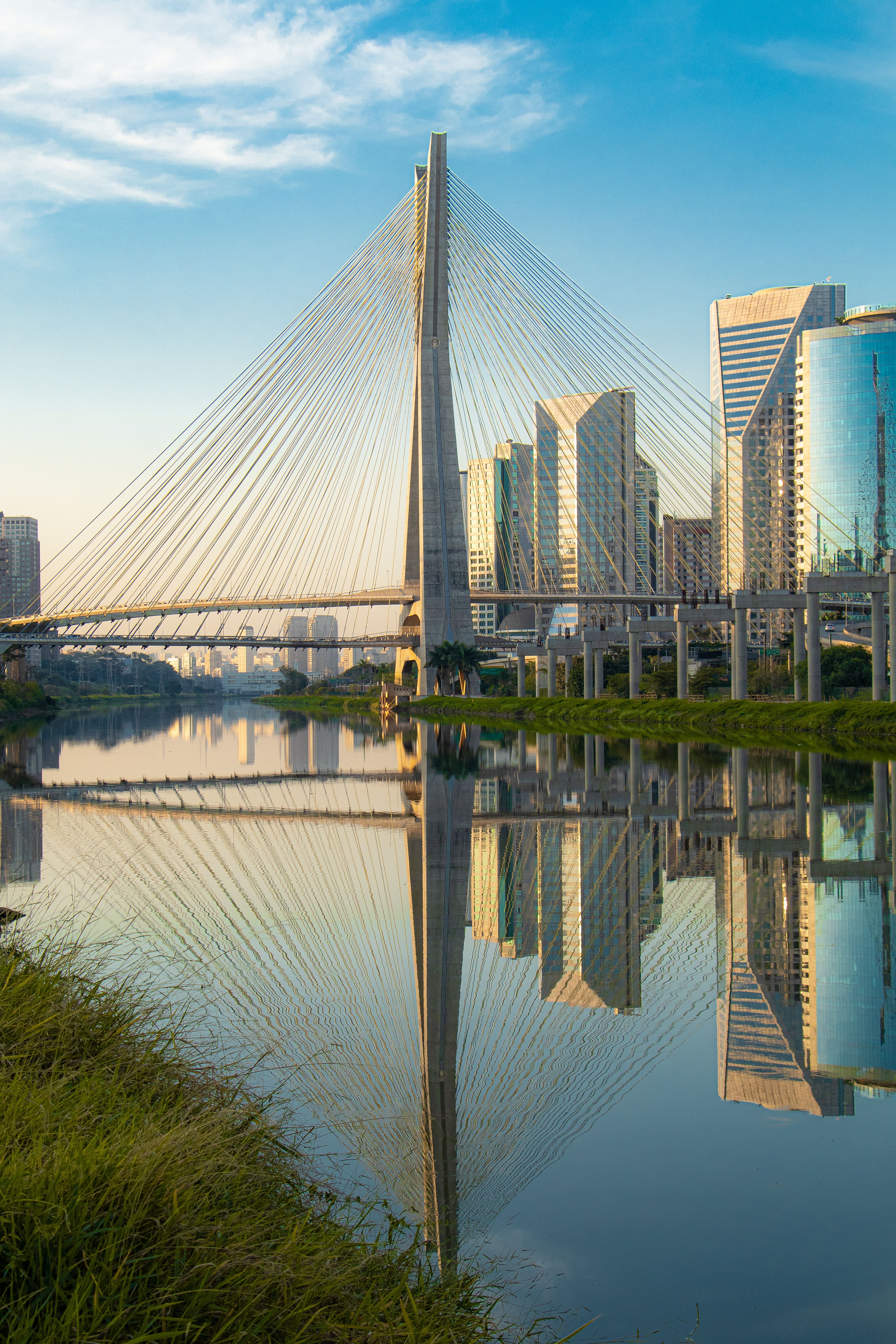 Stunning view of Ponte Octavio Frias de Oliveira reflecting over the water in São Paulo at sunrise.