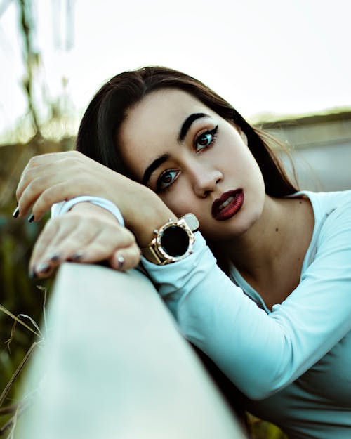 Portrait of a Woman Leaning on a Handrail while Looking at the Camera