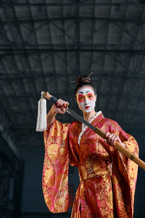 Free A Woman in a Kimono Holding a Sword Stock Photo