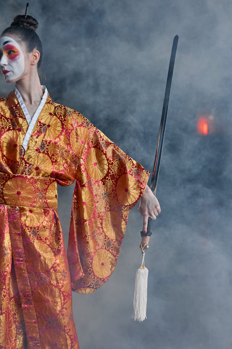 A Woman In A Kimono Holding A Sword