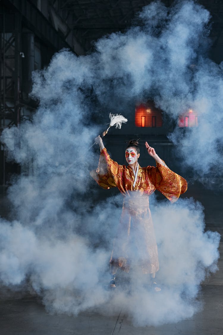 A Woman In A Kimono Holding A Sword