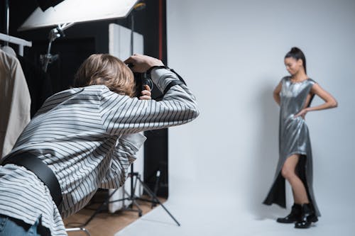 A Woman in Striped Shirt Taking a Photo