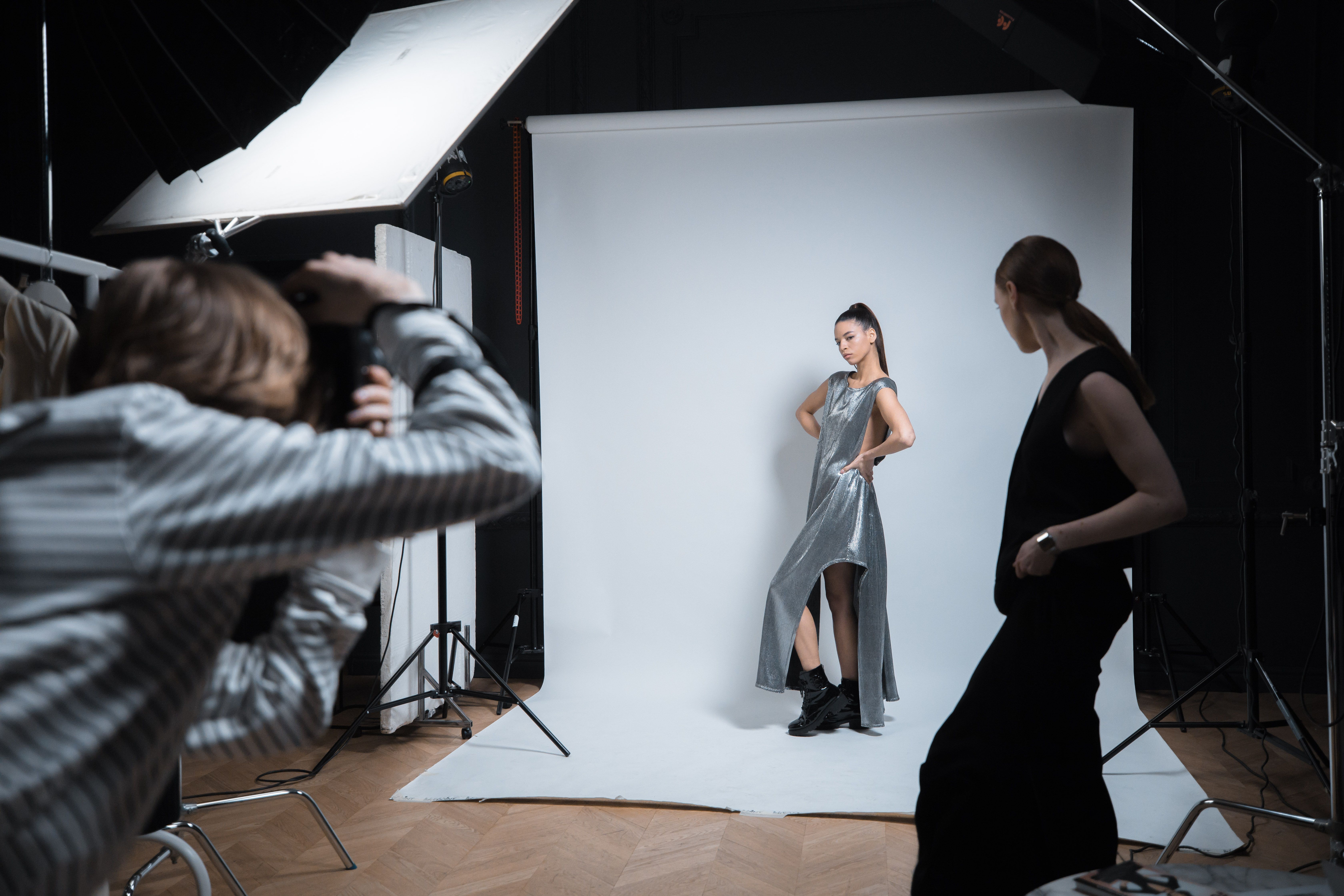 A model posing for a photoshoot in front of a cameraperson