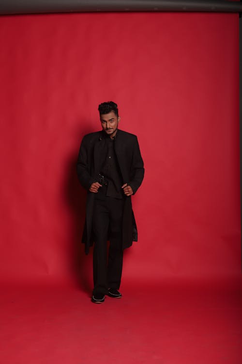Man in Black Coat Standing on Floor
