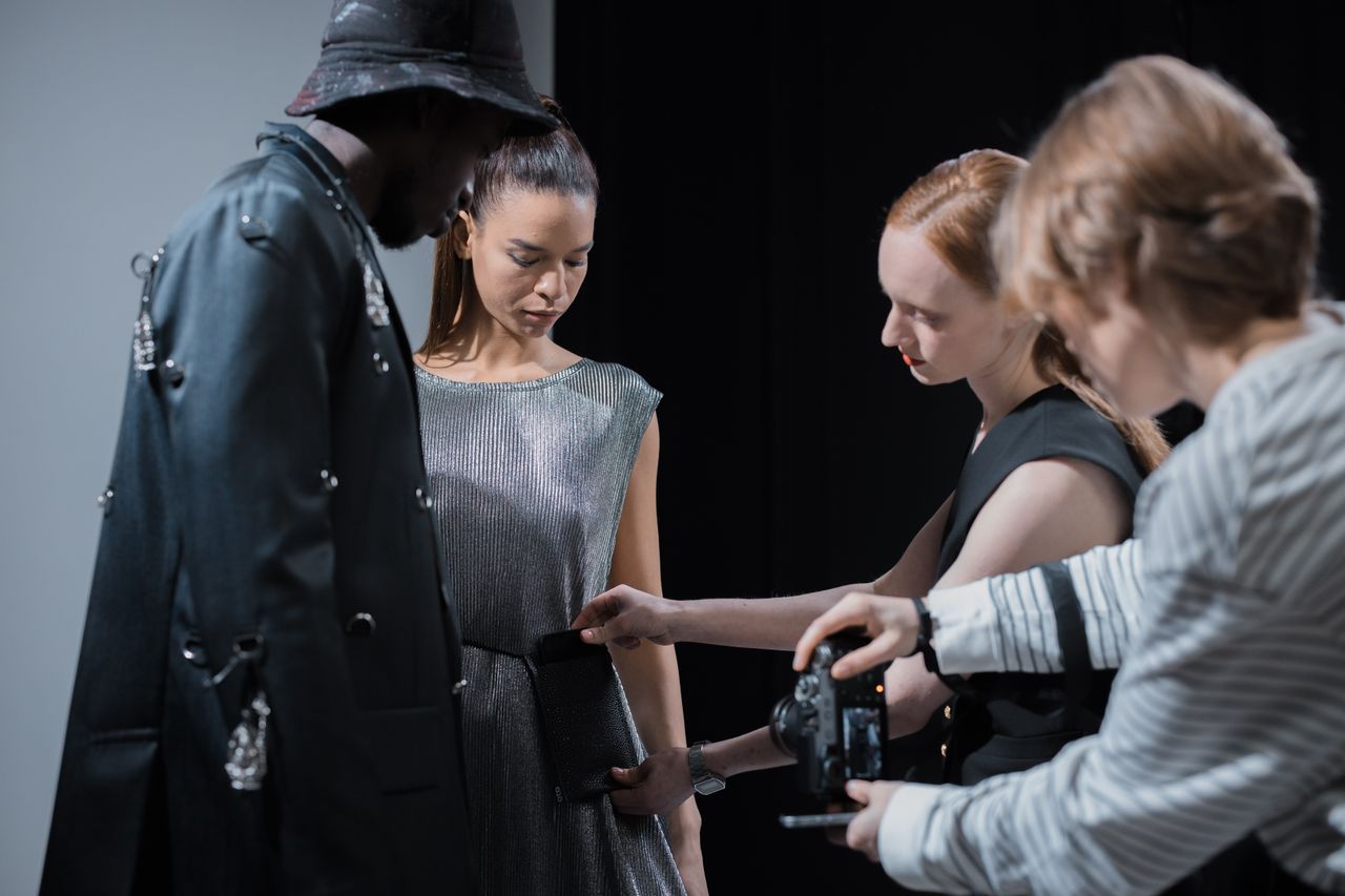 elegant fashion shoot with models and designer in studio setting