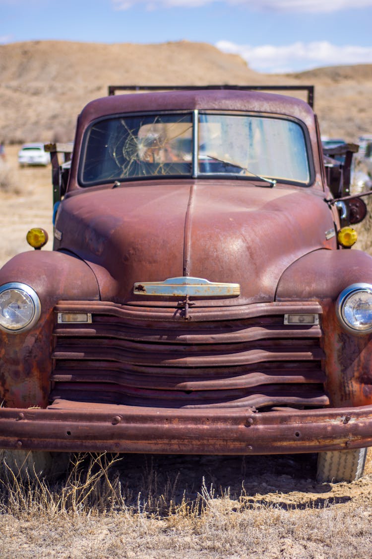 A Vintage Car With A Broken Windshield