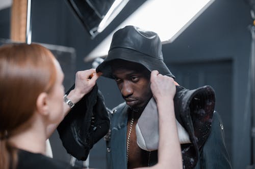 Stylist Choosing a Bucket Hat for a Model