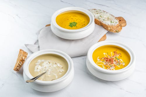 Free Close-Up Shot of Soup in a Bowl beside a Bread Stock Photo