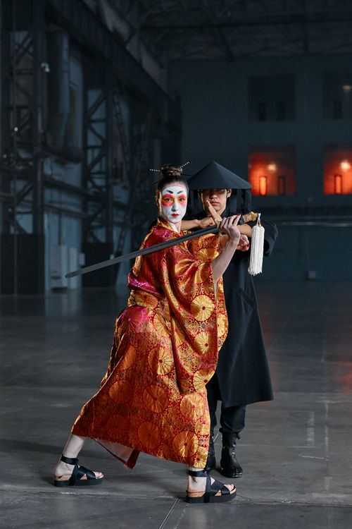 Free Captivating cosplay scene with a samurai and geisha in a dramatic pose. Stock Photo