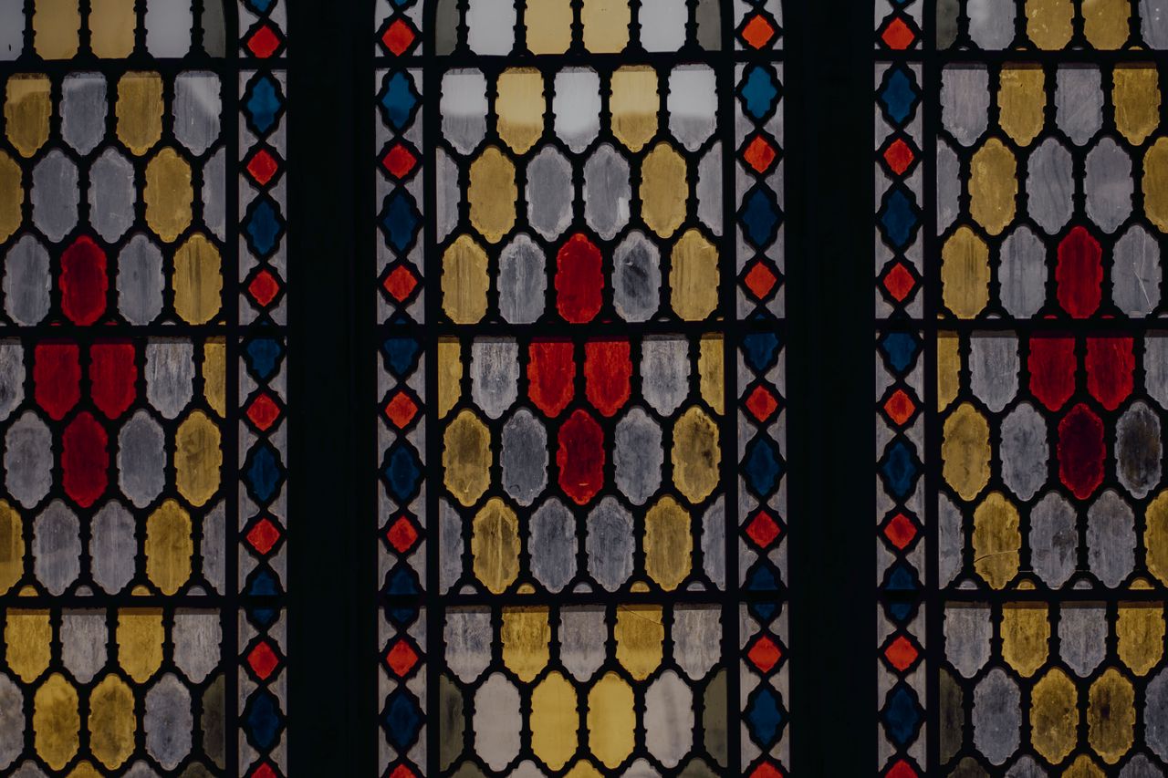 amazing colorful abstract symmetrical stained glass window with dark w