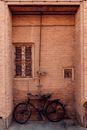 Bicycle parked near brick building