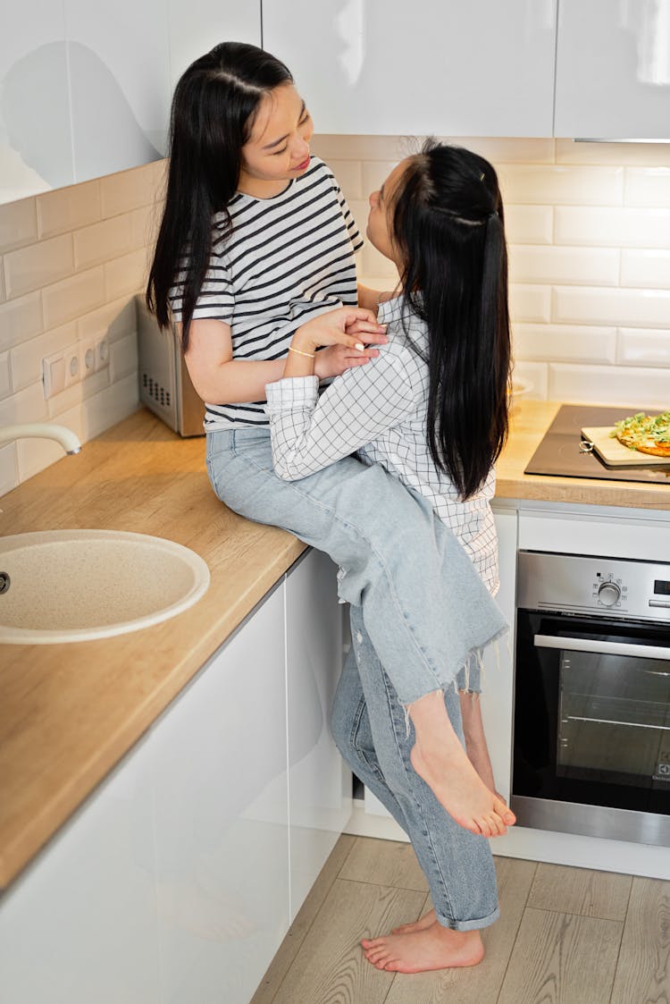 Couple Hugging While In The Kitchen