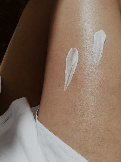 Close-Up Photo of White Cream on a Person's Lap