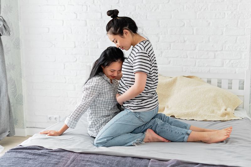 A loving couple shares a tender moment, embracing in anticipation of their new family addition.
