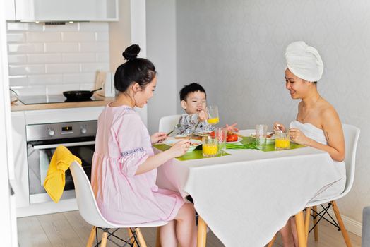 A family enjoys breakfast together at home, fostering bonding and joy.