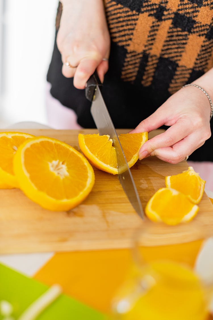 Close Up Photo Of Person Slicing Fruit