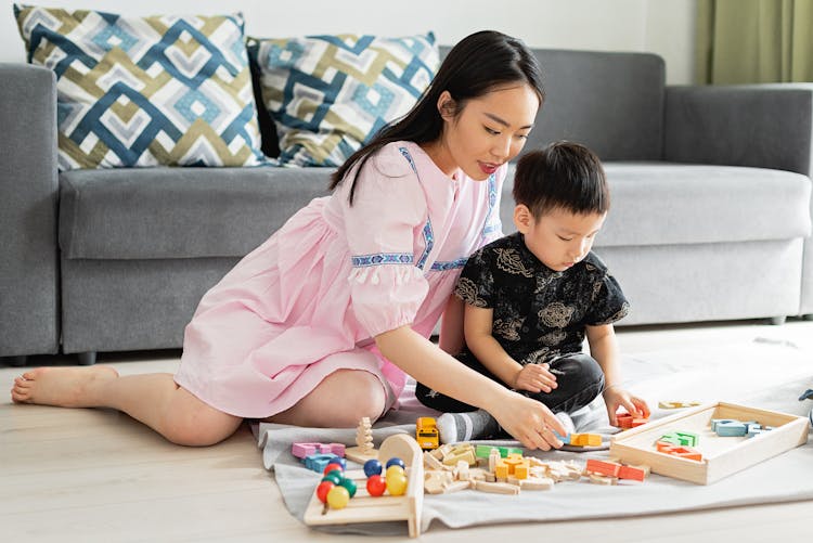 A Woman And Boy Playing Toys Together 