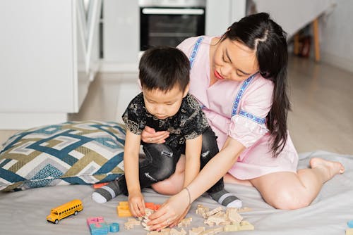 A Mother and Son Plying with Toys