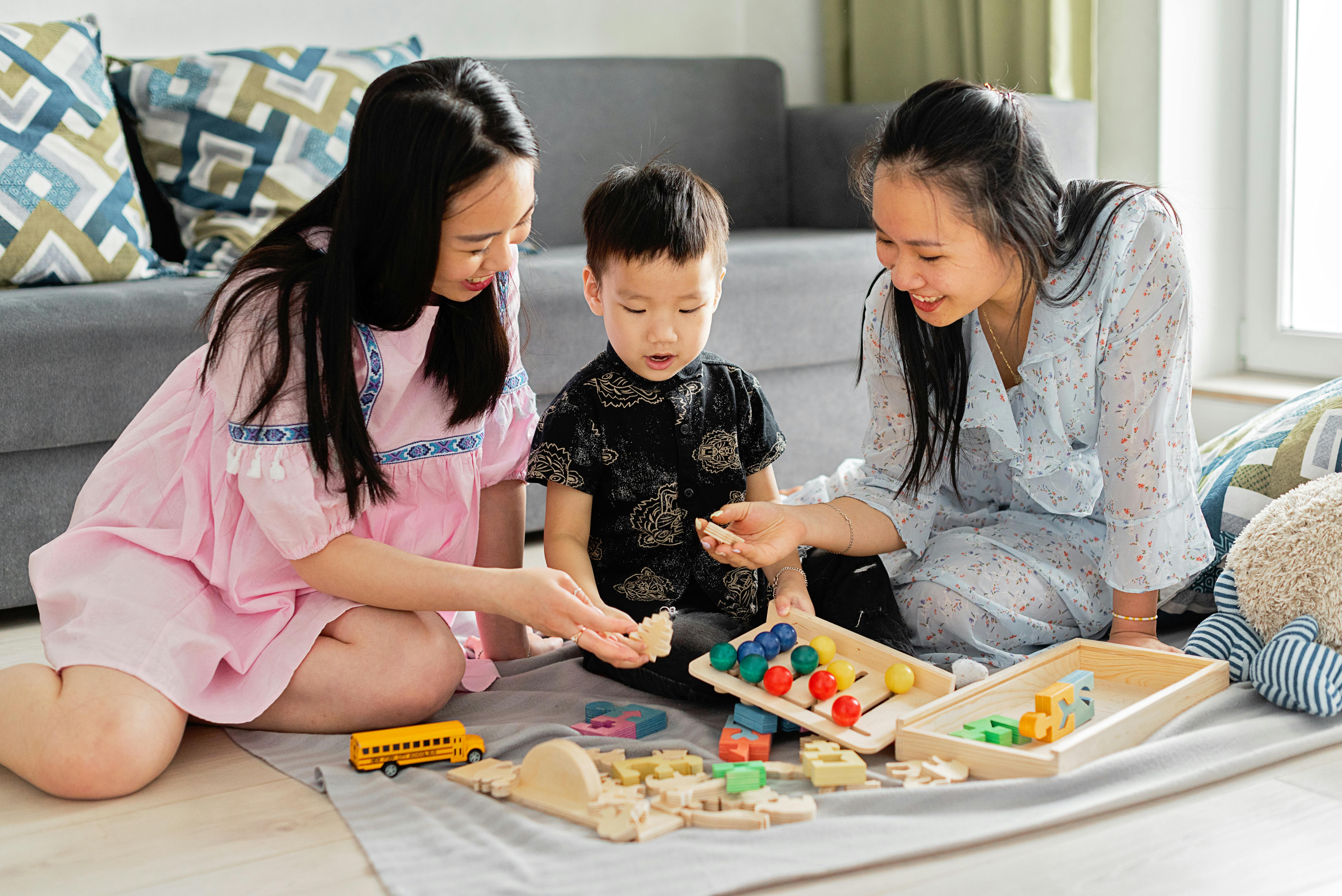 two women playing with a boy